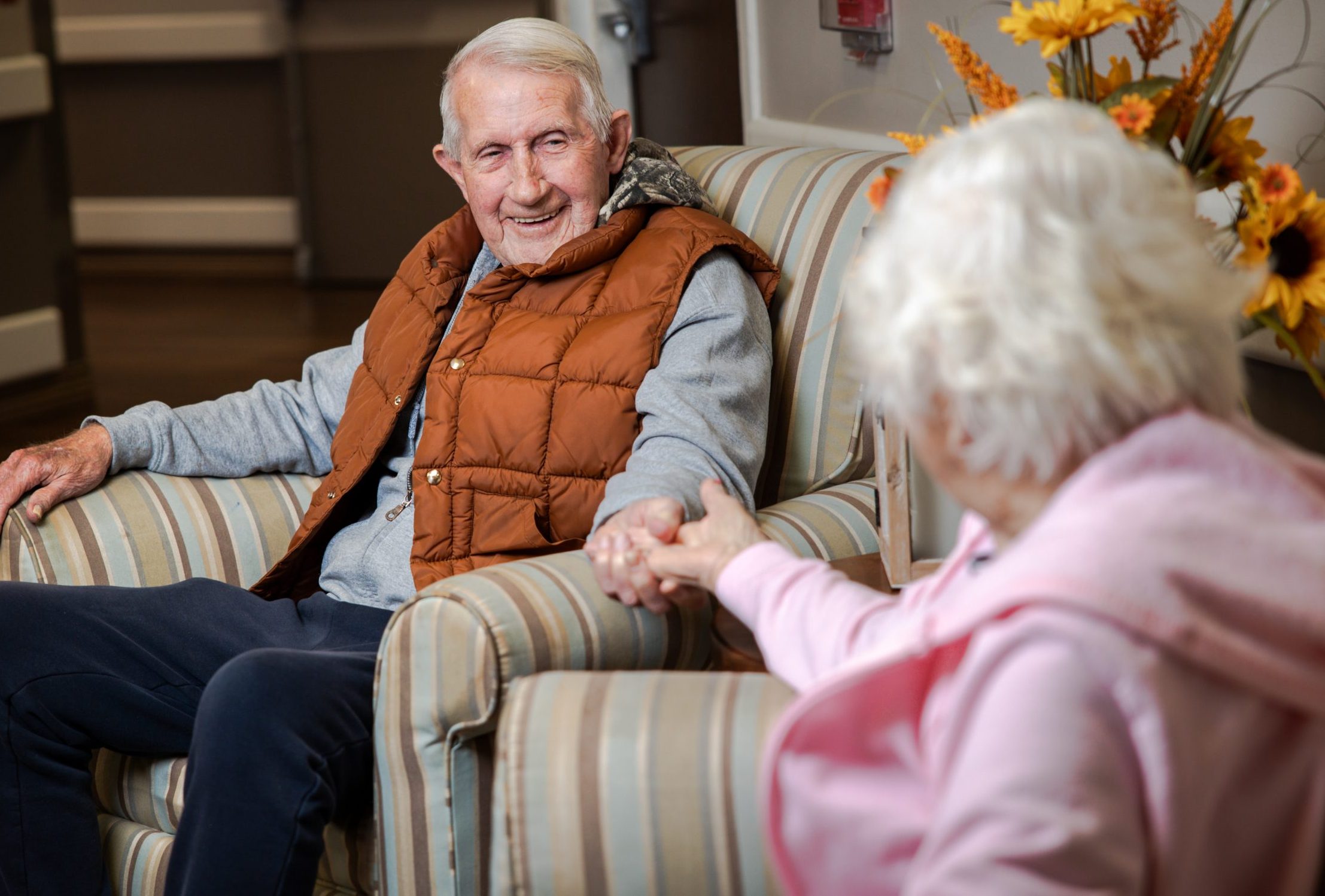 two residents sitting and talking with each other